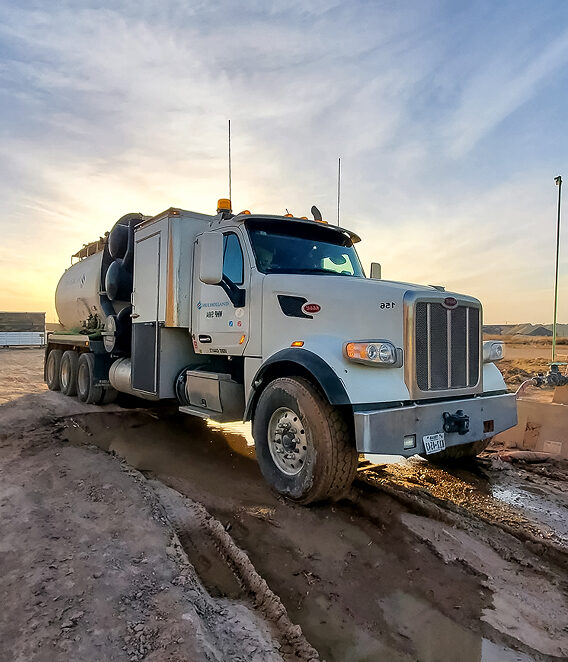 A large truck parked on a dirt road.