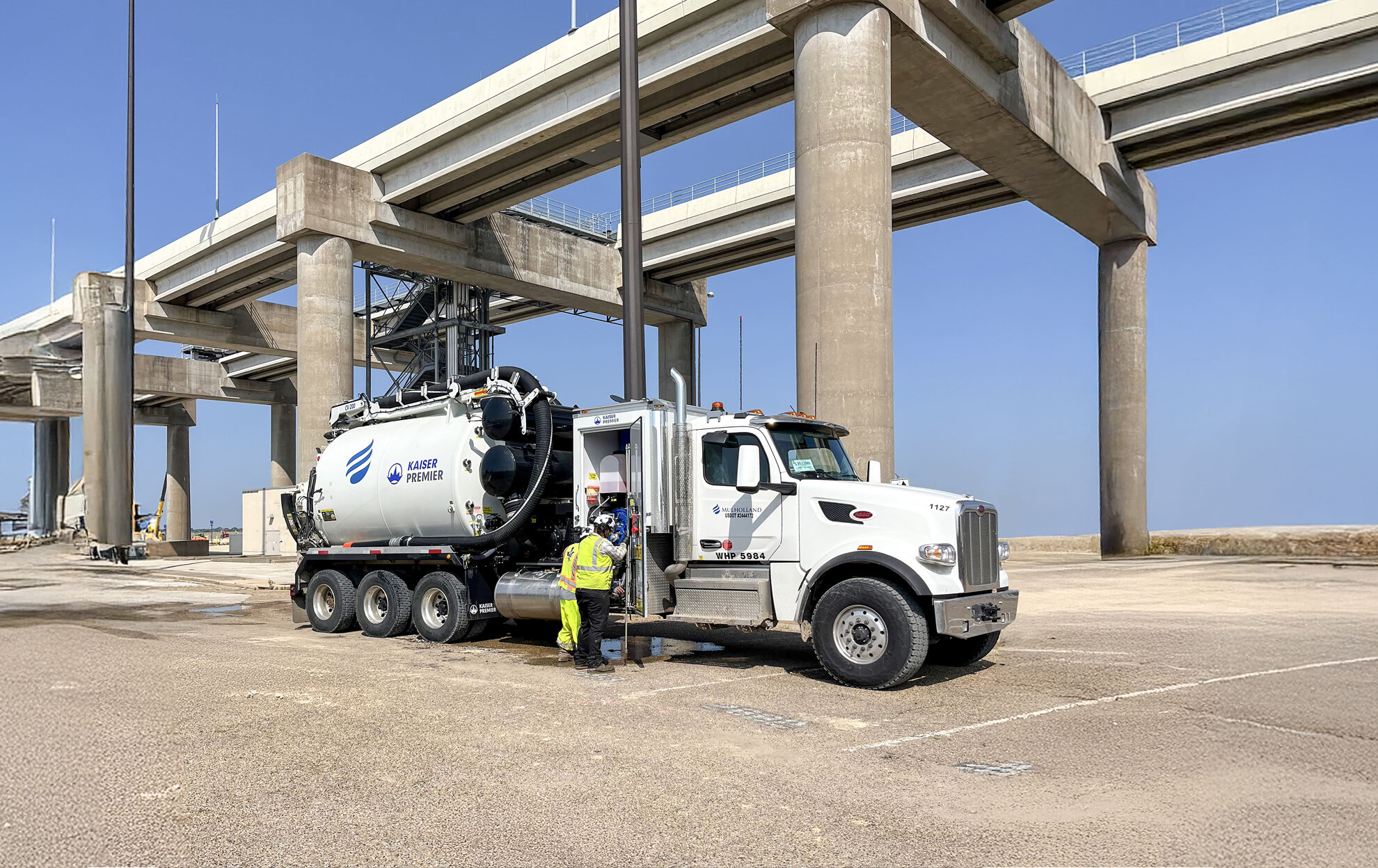 A man is standing next to a large truck.