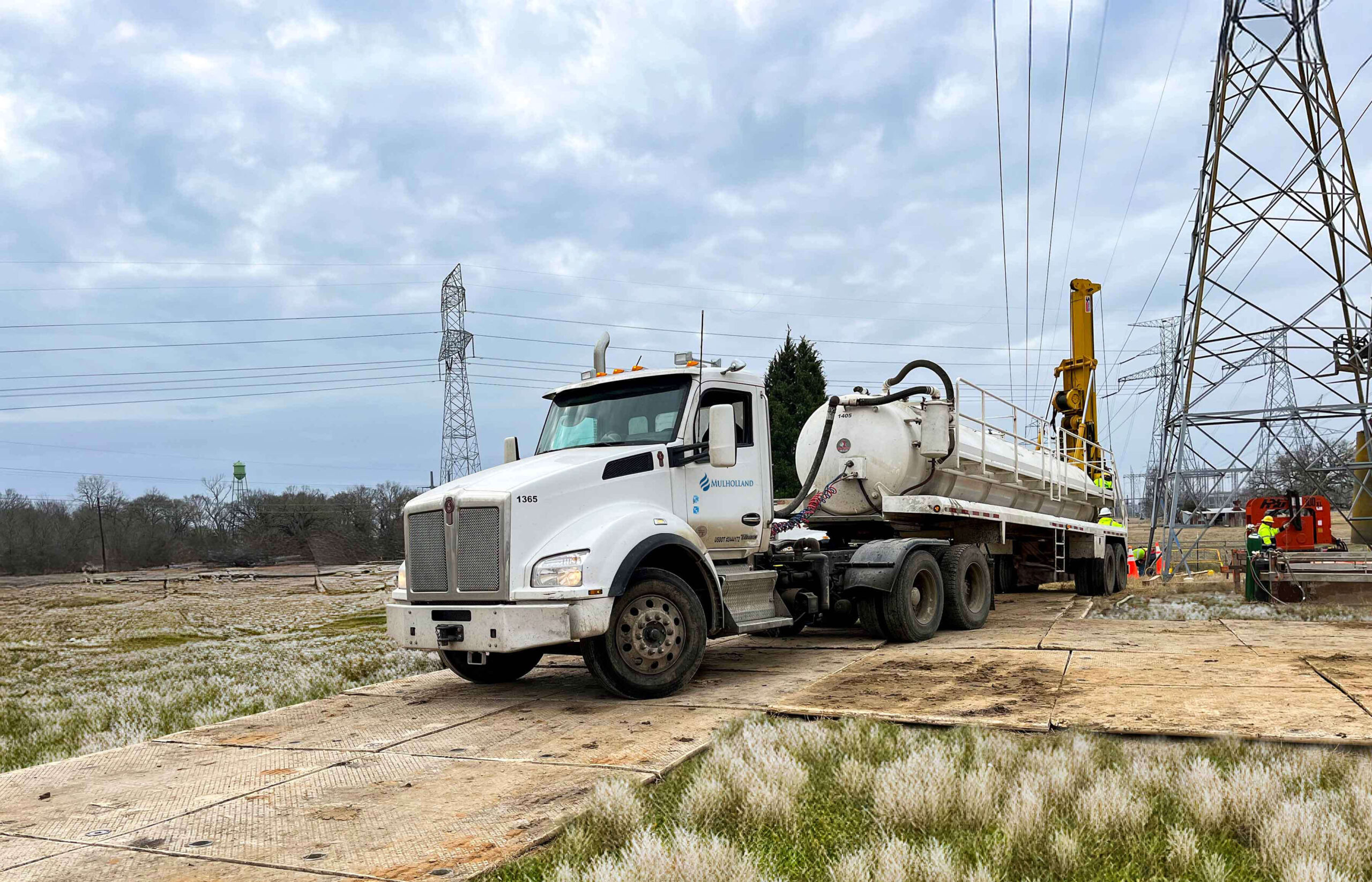 A truck is parked next to a power line.