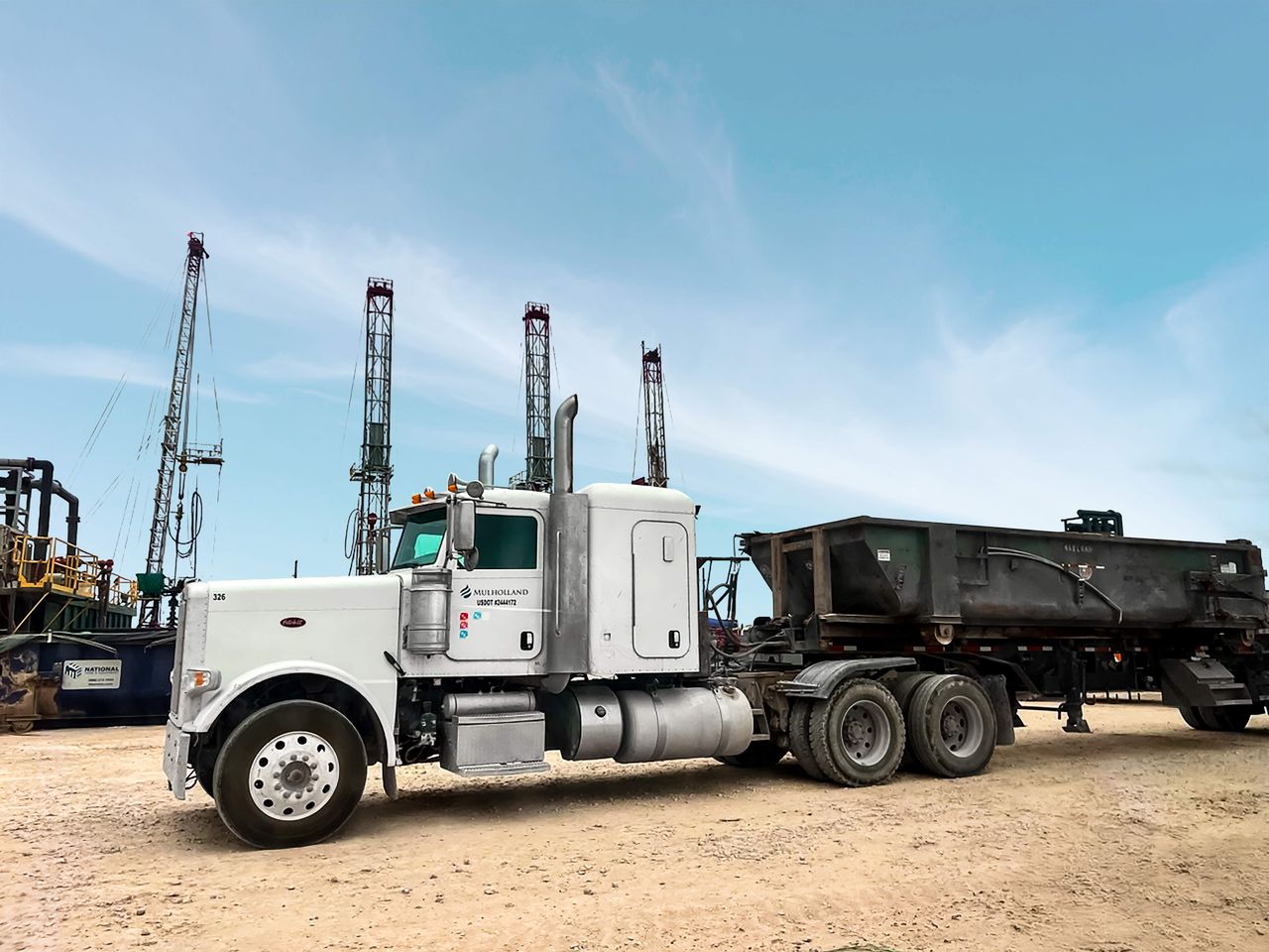 A truck is parked next to a power line.